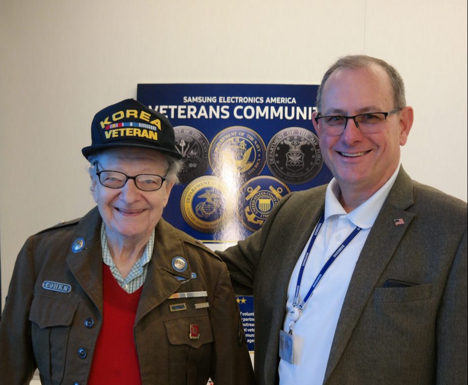 John Hendrick (right), veterans community chief advocate at Samsung Electronics America, poses for a photo with Sandy Cohen (left), a veteran from the 24th Infantry, Tropic Lightning Division, who served during the Korean War.