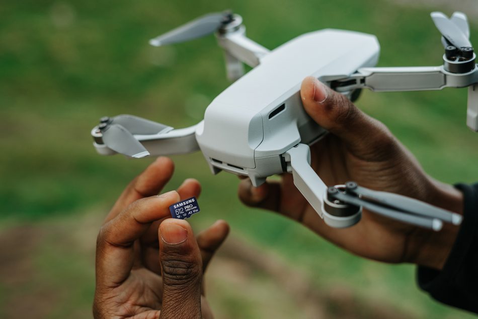 Samsung Pro Ultimate microSD memory card being inserted into a drone