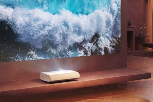 Samsung Premiere 9 short throw projector in front of a large screen